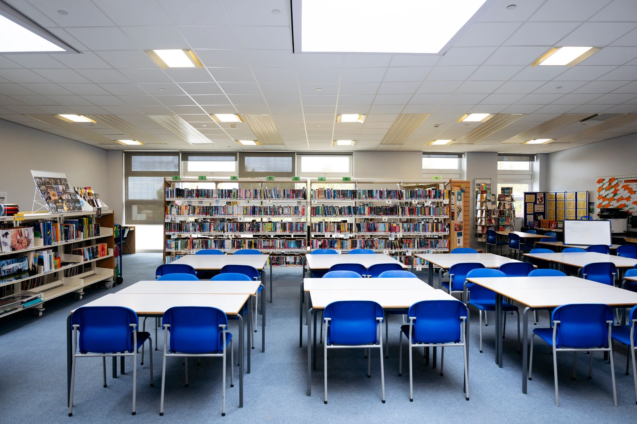 Quiet research library with desks and bookshelves