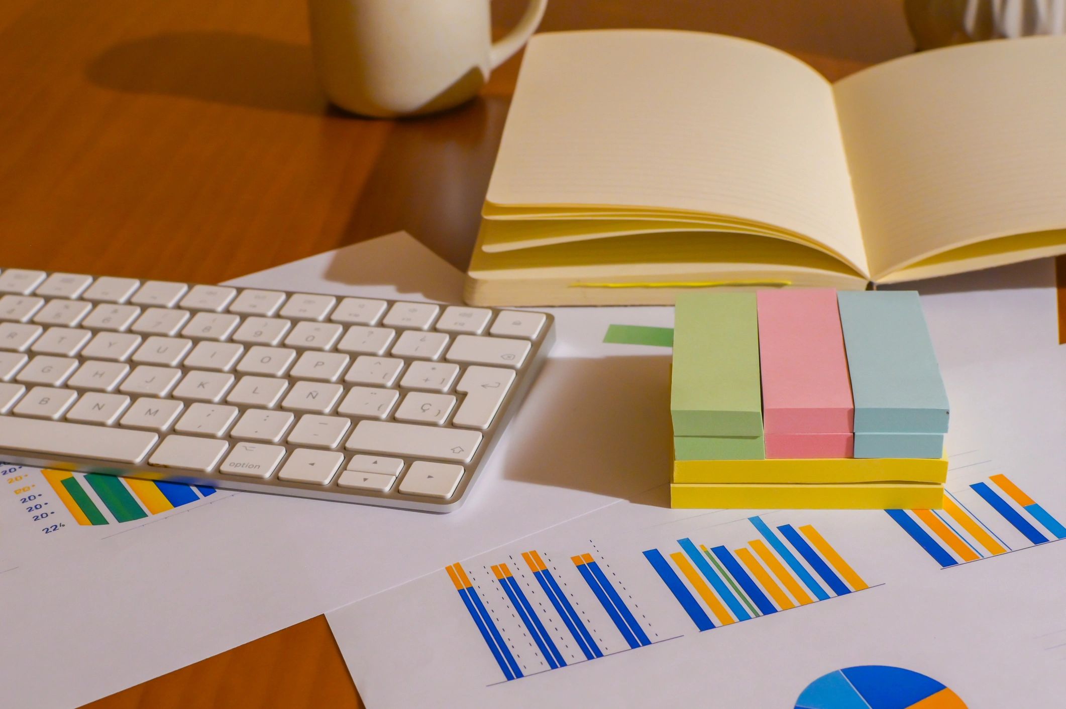 Desk with notebook and charts representing downloadable procurement research briefs