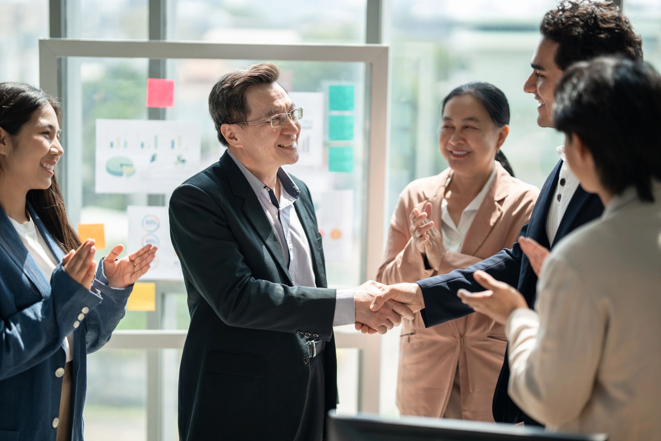 Team members applauding during a business meeting